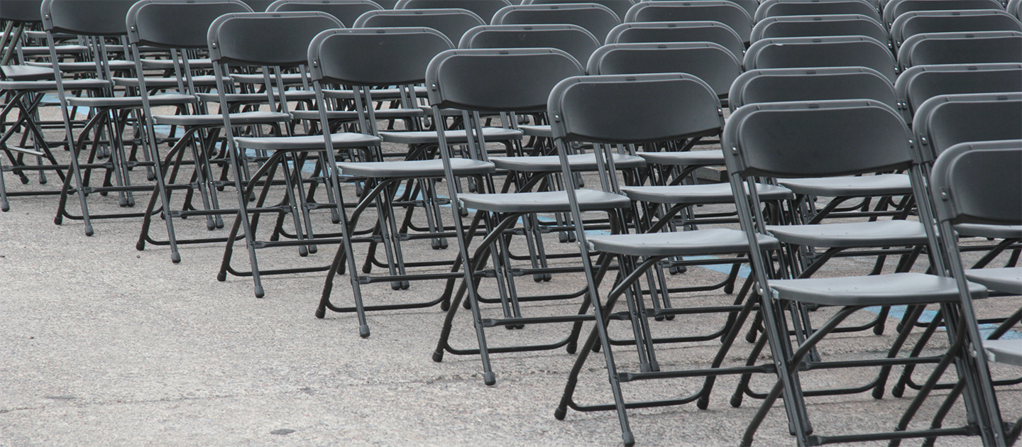 Rows of folding chairs representing seating